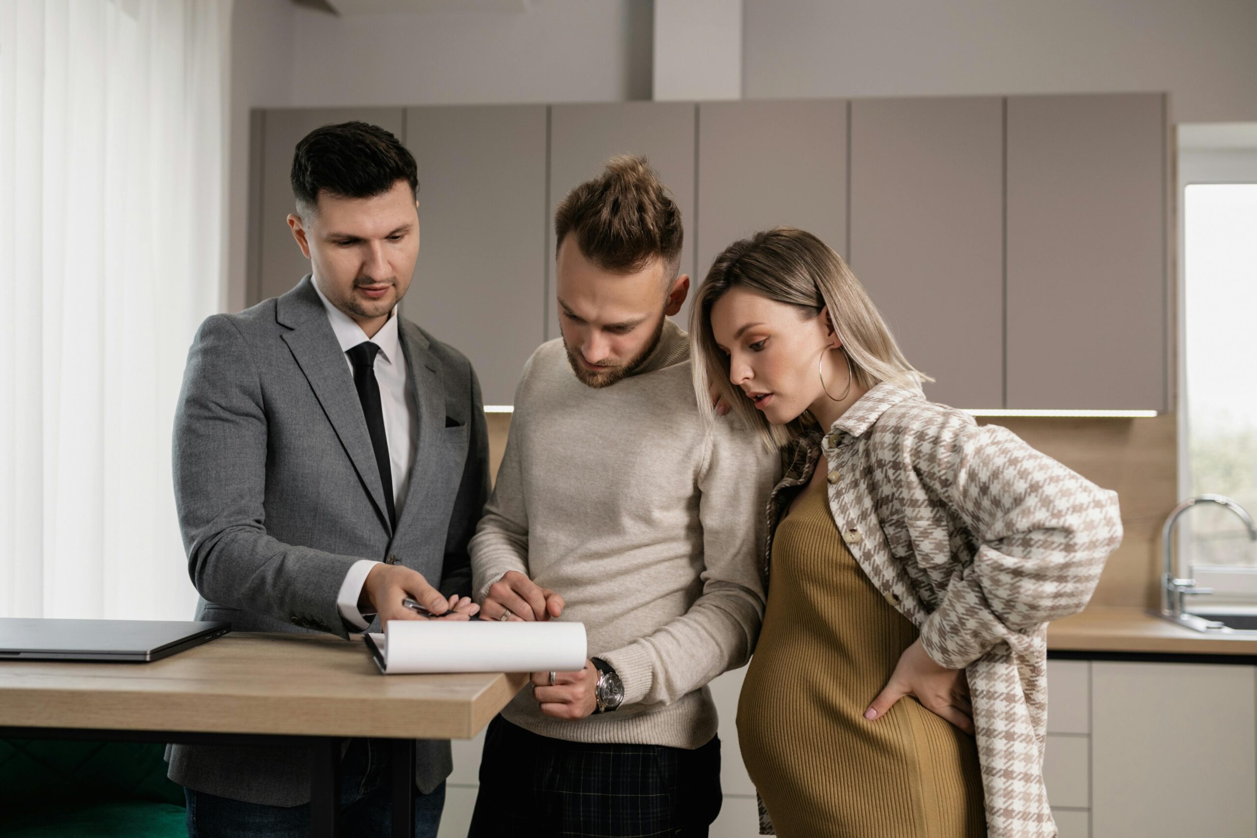 Man in Gray Jacket Showing Documents to a Man and Pregnant Woman · Free  Stock Photo